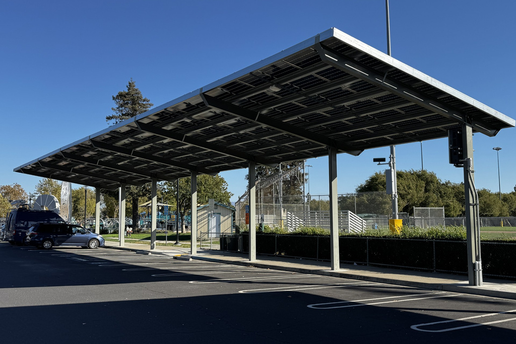 This photo taken with a smartphone shows solar panels covering a parking lot at Dublin Sports Grounds in Dublin, Calif., Monday, Sept. 28, 2026. (AP Photo/Terry Chea)