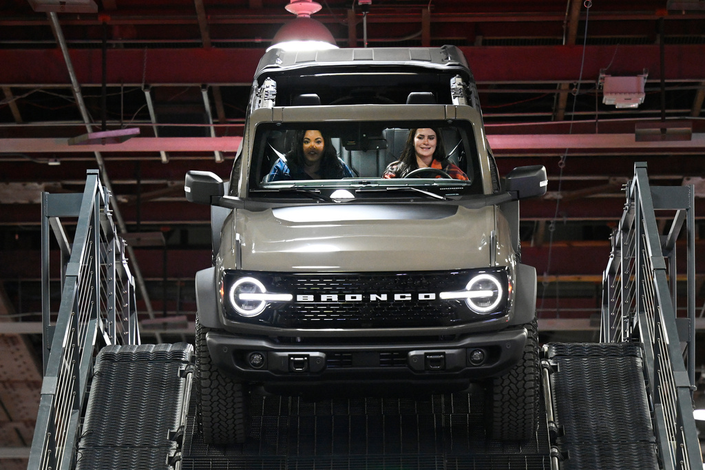 A guest is driven in a Ford Bronco on a test drive course by a Ford employee at the Detroit Auto Show, Wednesday, Jan. 14, 2026, in Detroit. (AP Photo/Jose Juarez)