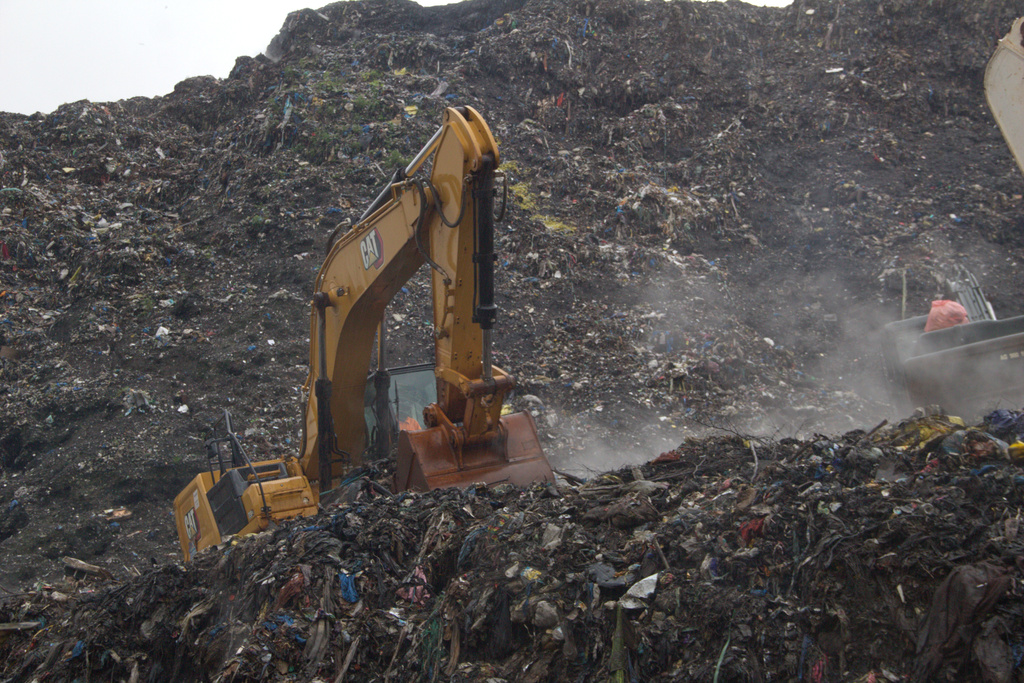 Rescue workers search through a heap of refuse after it collapsed at Conakry’s largest landfill, Guinea, Sunday, Aug. 23, 2026. (AP Photo/Fodo Toure)