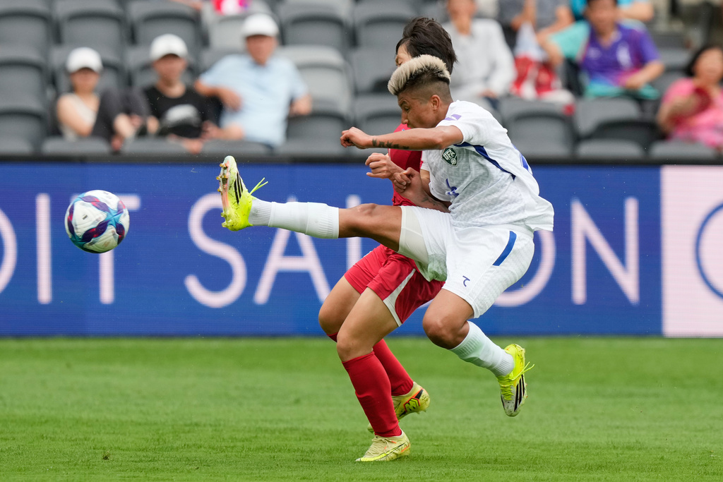 Uzbekistan's Dilrabo Asadova right, battles for the ball with North Korea's Chae Un Yong during the Women's Asia Cup soccer match between North Korea and Uzbekistan in Sydney, Tuesday, March 3, 2026. (AP Photo/Rick Rycroft)