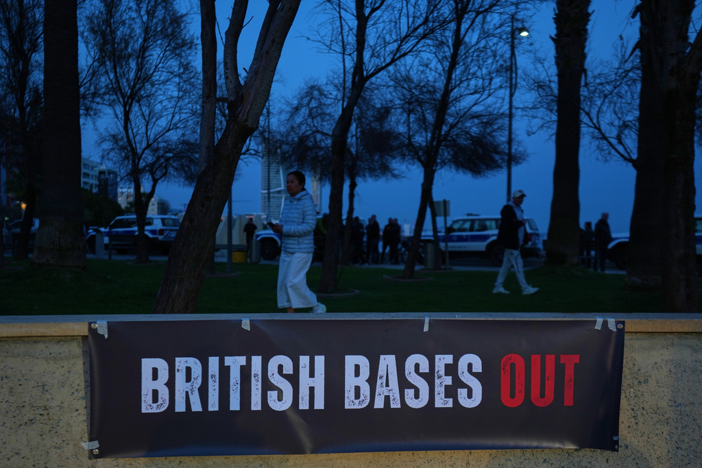 A phrase "British bases out," hangs during an anti-war rally in the southern city of Limassol, Cyprus, Tuesday, March 3, 2026. (AP Photo/Petros Karadjias)