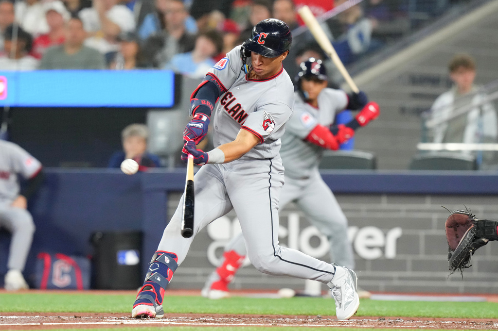 Cleveland Guardians' Juan Brito hits a double off Toronto Blue Jays pitcher Kevin Gausman during the third inning during the third inning of a baseball game in Toronto, Saturday, April 25, 2026. (Chris Young/The Canadian Press via AP)