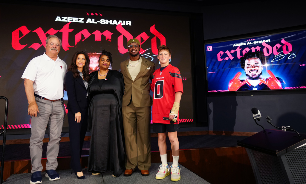 Houston Texans' Azeez Al-Shaair with his mother, Naadhirah Lennon, center, and Texan's owner Cal McNair, his wife, Hannah and their son, Calhoun McNair, far right, pose during a press conference at the NFL football team's facility, Friday, May 1, 2026, in Houston. (AP Photo/Karen Warren)