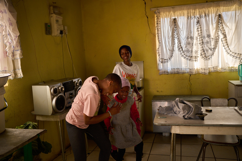 FILE - Children who are part of an HIV peer support network dance to music inside a home in Mafeteng, Lesotho, July 12, 2025. (AP Photo/Bram Janssen, File)