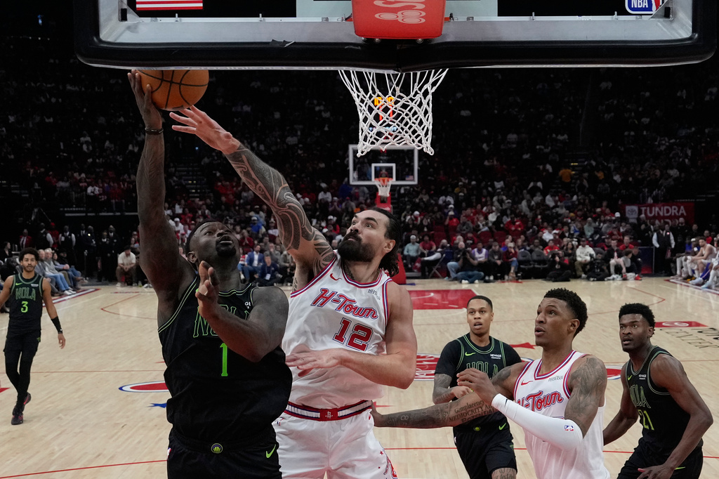 New Orleans Pelicans forward Zion Williamson (1) shoots against Houston Rockets center Steven Adams (12) during the first half of an NBA basketball game in Houston, Sunday, Jan. 18, 2026. (AP Photo/Ashley Landis)