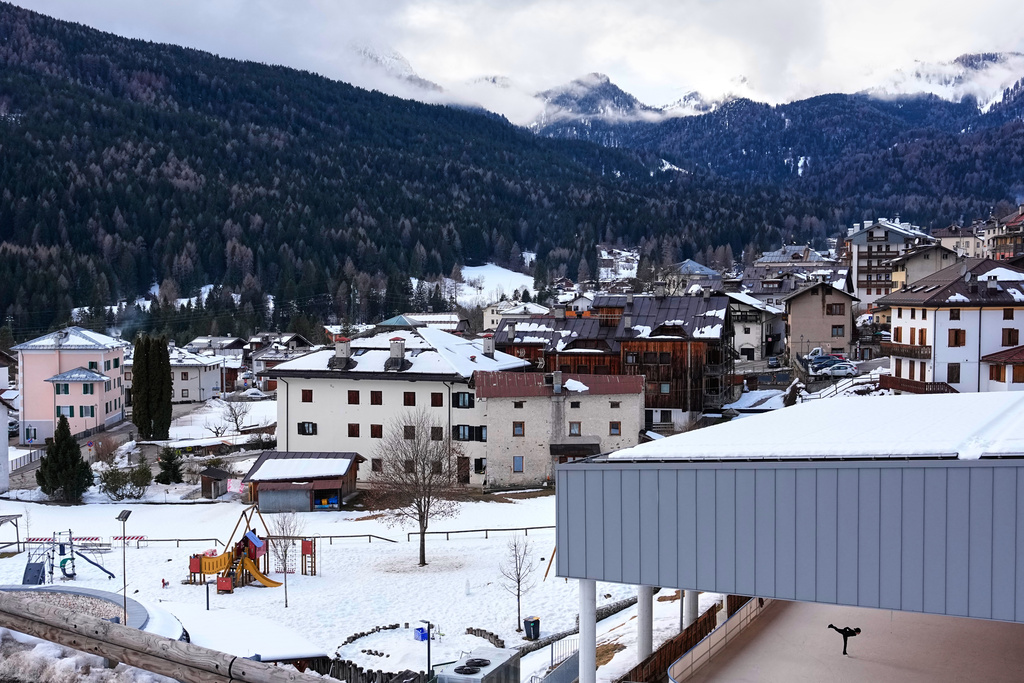 A young girl practices figure skating at an ice skating rink in Borca di Cadore, a small town near Cortina d'Ampezzo, Italy, one of the sites of the 2026 Winter Olympics, Wednesday, Feb. 11, 2026. (AP Photo/Andy Wong)