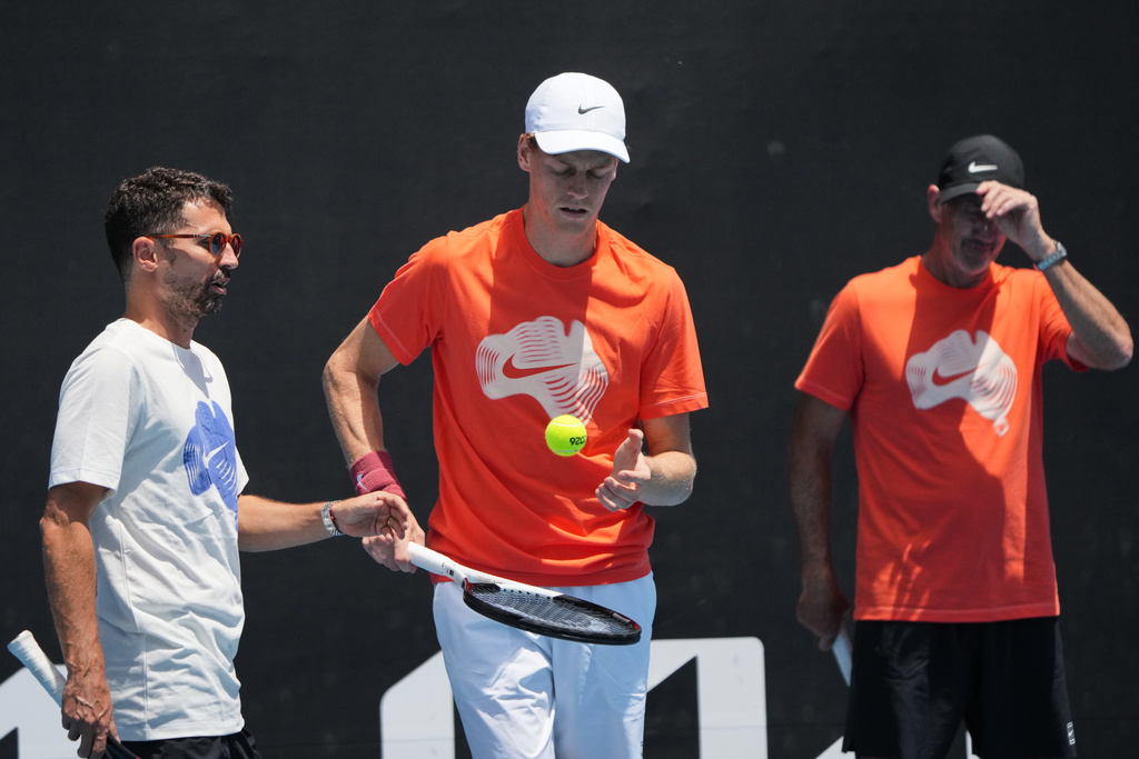 Jannik Sinner of Italy talks with coach Simone Vagnozzi, left, during a practice session ahead of the Australian Open tennis championship in Melbourne, Australia, Friday, Jan. 16, 2026. (AP Photo/Dita Alangkara)