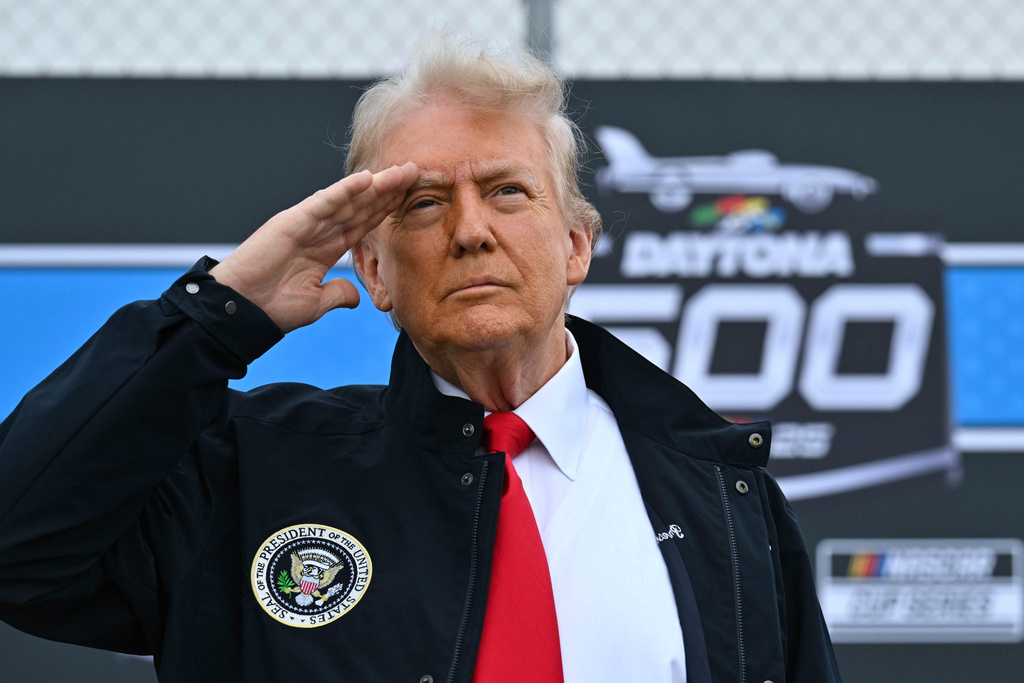 FILE - President Donald Trump salutes as he attends the NASCAR Daytona 500 auto race at Daytona International Speedway, Feb. 16, 2025, in Daytona Beach, Fla. (Pool via AP, File)