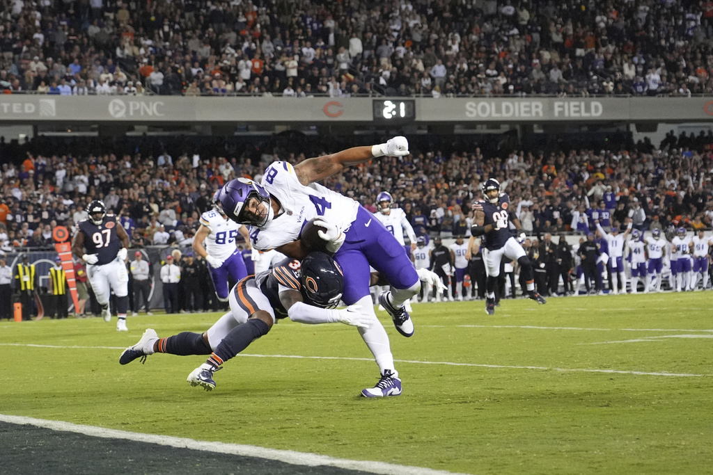 Minnesota Vikings tight end Josh Oliver, right, is stopped short of the end zone by Chicago Bears defensive back Jonathan Owens during the second half of an NFL football game Monday, Sept. 8, 2025, in Chicago. (AP Photo/Nam Y. Huh)