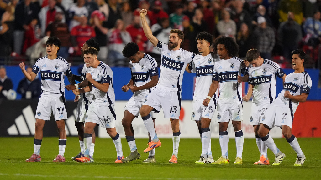 The Vancouver Whitecaps line celebrate a penalty kick goal scored by Belal Halbouni during Game 2 in the first round of MLS soccer's Western Conference playoffs against the FC Dallas in Frisco, Texas, Saturday, Nov. 1, 2025. (AP Photo/LM Otero)