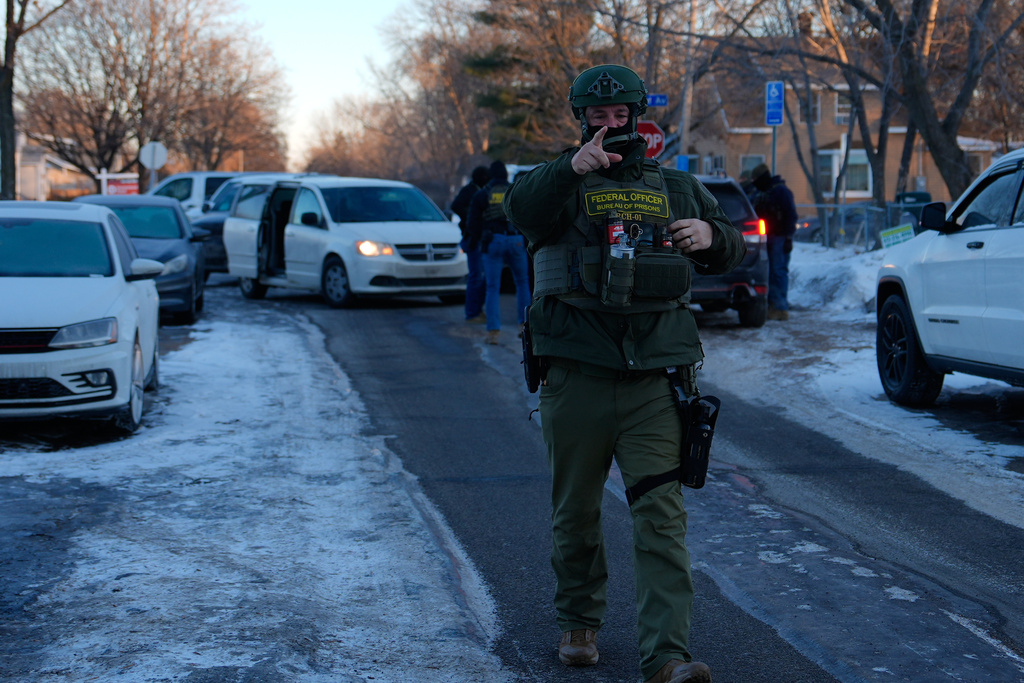 A federal officer approaches observers and journalists on Wednesday, Jan. 28, 2026, in Minneapolis. (AP Photo/Julia Demaree Nikhinson)