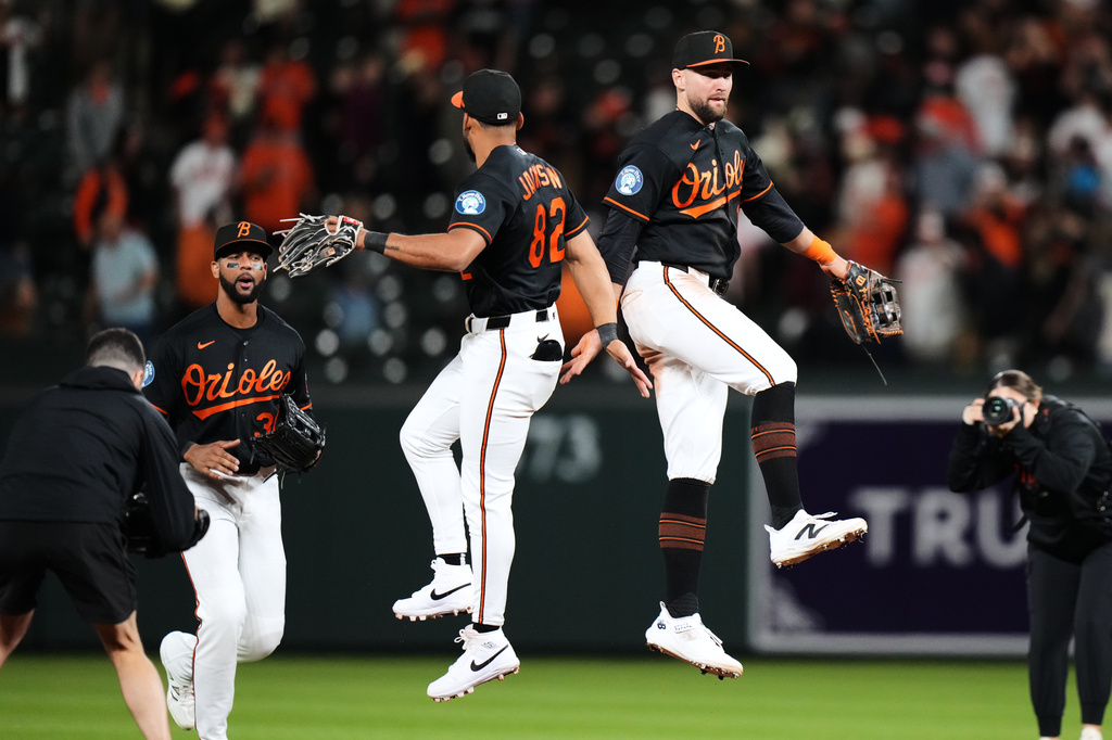 From left, Baltimore Orioles center fielder Leody Taveras (30), second baseman Jeremiah Jackson (82) and right fielder Colton Cowser celebrate their team's victory over the San Francisco Giants in a baseball game, Saturday, April 11, 2026, in Baltimore. (AP Photo/Stephanie Scarbrough)