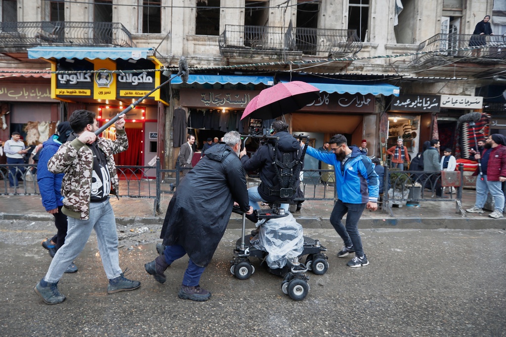 A television crew films an episode of the TV series "Al-Souriyoun al-Aada" ("The Syrian Enemies"), based on a novel of the same name that was banned under Bashar Assad, along a transformed street in central Aleppo, Syria, Friday, Feb. 13, 2026. (AP Photo/Omar Sanadiki)