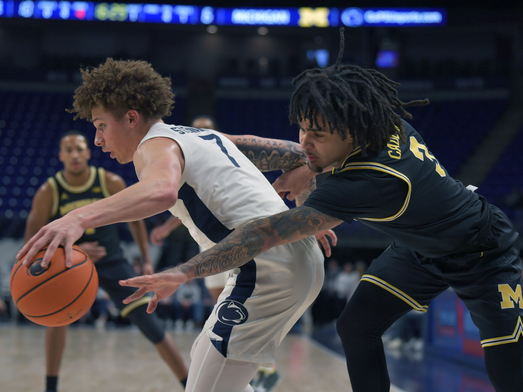 Michigan's Elliot Cadeau ,right, attempts to knock the ball away from Penn State's Dominick Stewart (7) during the first half of an NCAA college basketball game Tuesday, Jan. 6, 2026, in State College, Pa. (AP Photo/Gary M. Baranec)