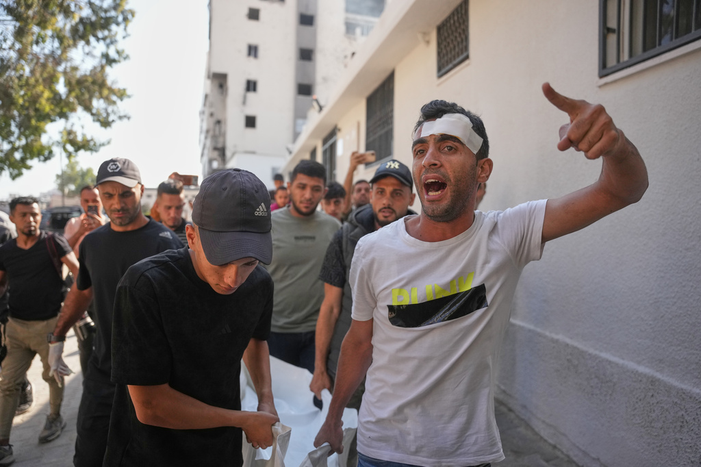 Mourners carry the bodies of two Palestinian girls Zeina Safadi, and her sister Lana, who were killed during an overnight Israeli airstrike that damaged their home, during their funeral in Gaza city, Saturday, June 20, 2026. (AP Photo/Abdel Kareem Hana)