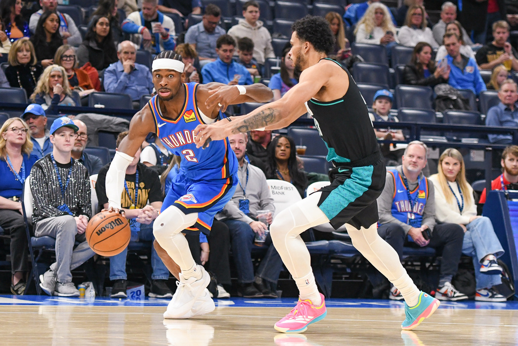 Oklahoma City Thunder guard Shai Gilgeous-Alexander, left, drives past Portland Trail Blazers forward Toumani Camara during the second half of an NBA basketball game, Wednesday, Dec. 31, 2025, in Oklahoma City. (AP Photo/Kyle Phillips)