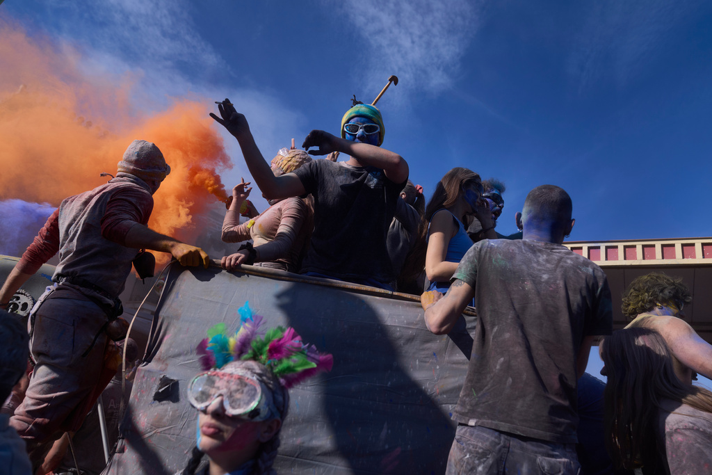 Revelers take part in the annual flour war marking the end of the Carnival season on Clean Monday in Galaxidi, about 200 kilometers (120 miles) west of Athens, Feb. 23, 2026, starting the 40-day Christian Lent fast leading to Easter. (AP Photo/Petros Giannakouris)