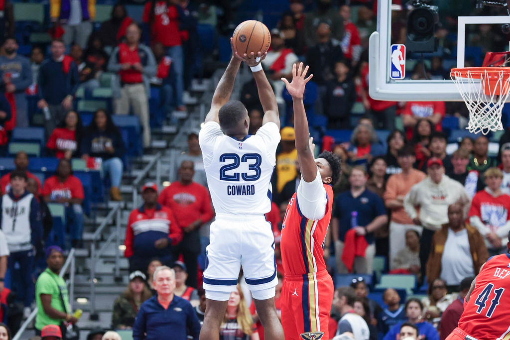 Memphis Grizzlies forward Cedric Coward (23) shoots a jumper over New Orleans Pelicans center Derik Queen in the first half of an Emirates NBA Cup basketball game, Wednesday, Nov. 26, 2025, in New Orleans. (AP Photo/Peter Forest)
