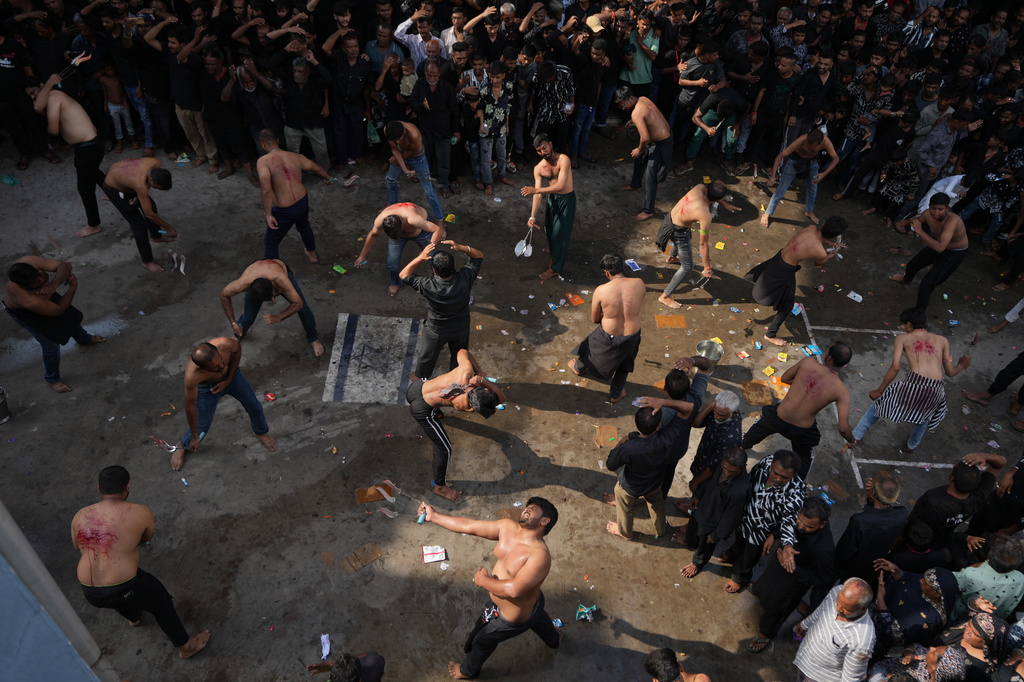 Shiite Muslims flagellate themselves during a Muharram procession in Ahmedabad, India, Tuesday, June 23, 2026. (AP Photo/Ajit Solanki)