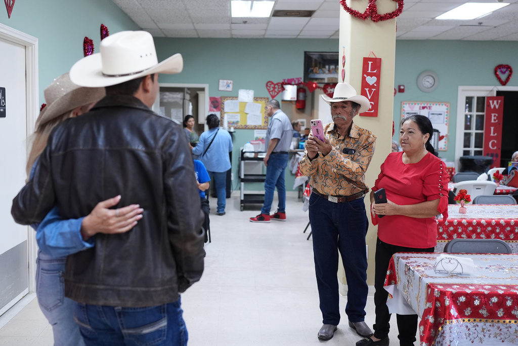 Democratic candidate for congress Bobby Pulido, left, poses for photos during a campaign stop in Pharr, Texas, Tuesday, Feb. 10, 2026. (AP Photo/Eric Gay)