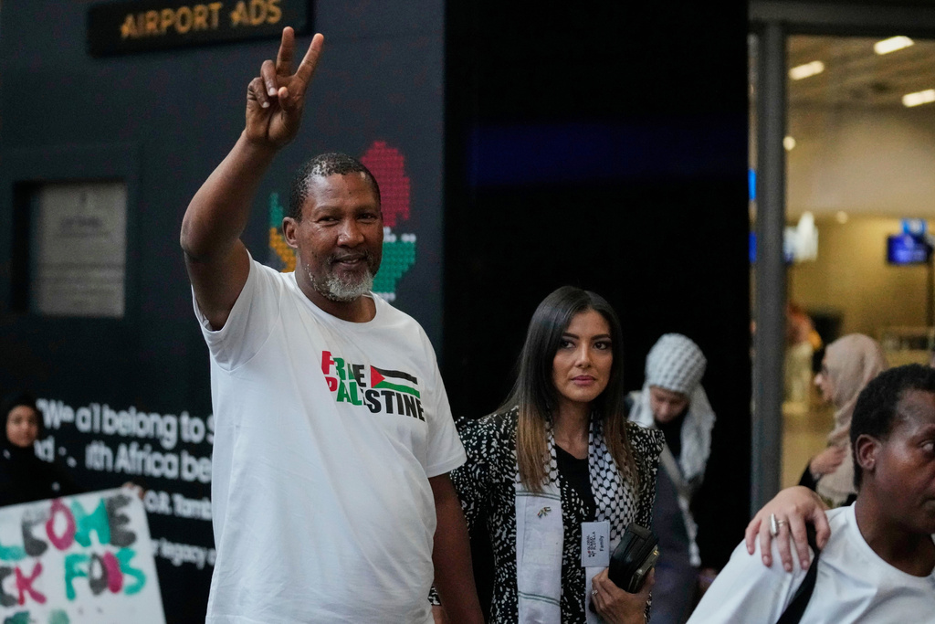 Mandla Mandela with his wife Rabia, arrives with members of the Global Sumud Flotilla, at OR Tambo International Airport, in Johannesburg, South Africa, Wednesday, Oct. 8, 2025. (AP Photo/Themba Hadebe)