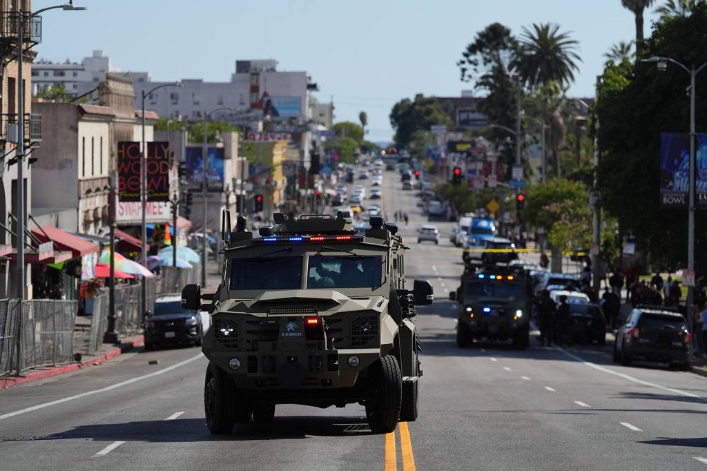 Law enforcement vehicles are seen near MacArthur Park after federal authorities made arrests on charges related to selling illicit drugs on Wednesday, May 6, 2026, in Los Angeles. (AP Photo/Jae C. Hong)