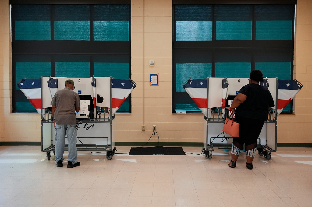 People vote at a polling place in a primary election Thursday, Aug. 6, 2026, in Memphis, Tenn. (AP Photo/George Walker IV)