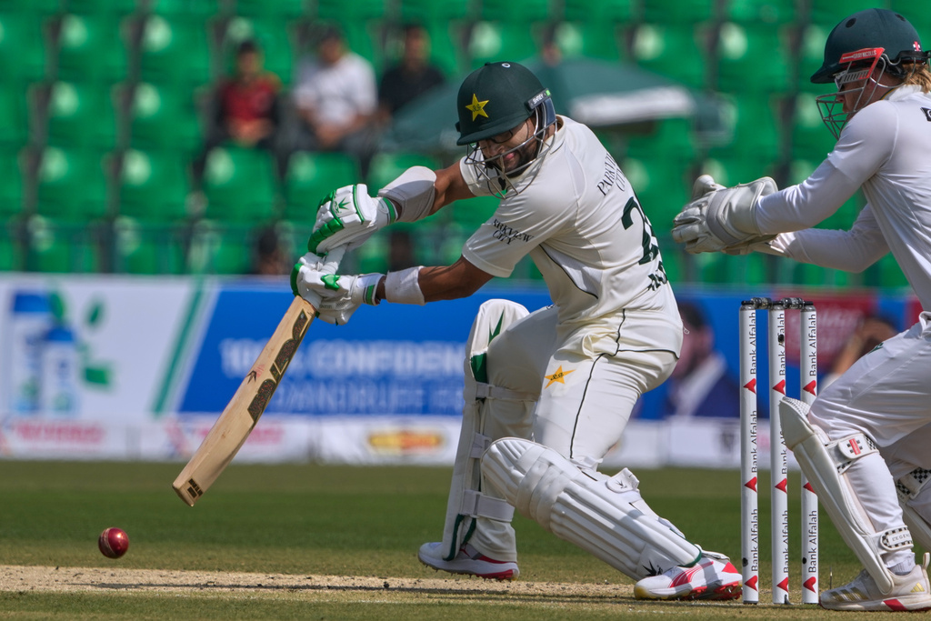 Pakistan's Imam-ul-Haq, center, plays a shot during the first day of of first test cricket match between Pakistan and South Africa, in Lahore, Pakistan, Sunday, Oct. 12, 2025. (AP Photo/K.M. Chaudary)