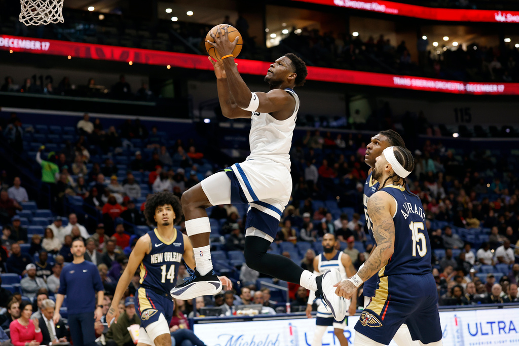 Minnesota Timberwolves guard Anthony Edwards (5) shoots a basket as New Orleans Pelicans guard Jose Alvarado (15) defends in the first half of an NBA basketball game, in New Orleans, Tuesday, Dec. 2, 2025. (AP Photo/Tyler Kaufman)
