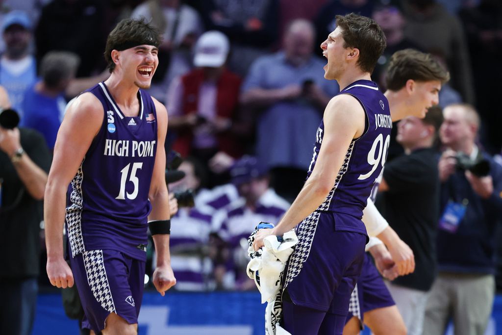 High Point forward Braden Hausen (15) celebrates with guard Chase Johnston, right, after the first round of the NCAA college basketball tournament against Wisconsin, Thursday, March 19, 2026, in Portland, Ore. (AP Photo/Amanda Loman)