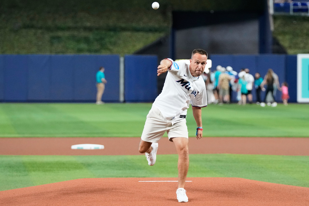 Miami Dolphins head coach Jeff Hafley tosses a baseball in the dugout before throwing a ceremonial pitch at a baseball game between the Miami Marlins and the Cleveland Guardians, Sunday, July 12, 2026, in Miami. (AP Photo/Lynne Sladky)