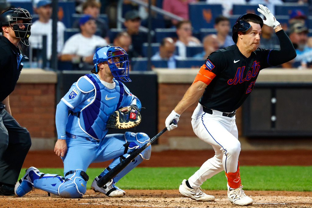 New York Mets' Jared Young grabs his helmet after hitting a pop fly ball for an out against the Kansas City Royals during the fourth inning of a baseball game, Wednesday, July 8, 2026, in New York. (AP Photo/Noah K. Murray)