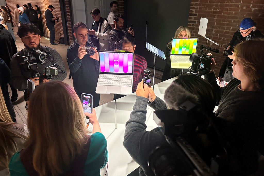 Members of the media view MacBook Neo laptop computers on display during an Apple unveil event, Wednesday, March 4, 2026, in New York (AP Photo/Ted Shaffrey) ,