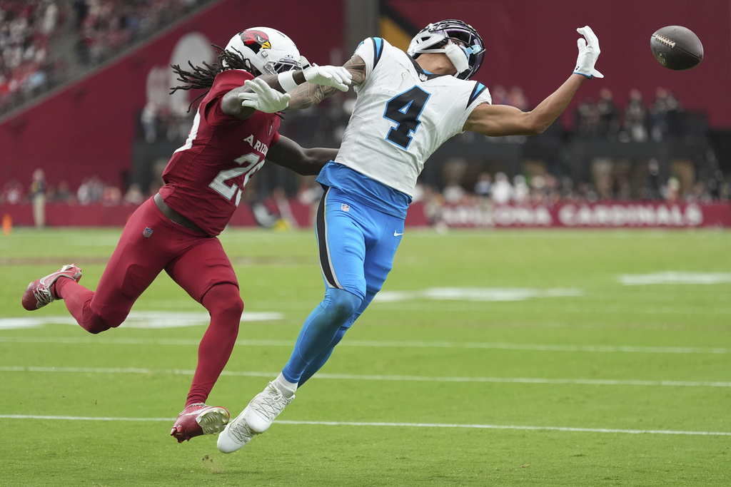 Carolina Panthers wide receiver Tetairoa McMillan (4) can't make the catch as Arizona Cardinals cornerback Denzel Burke defends during the second half of an NFL football game, Sunday, Sept. 14, 2025, in Glendale, Ariz. (AP Photo/Ross D. Franklin)