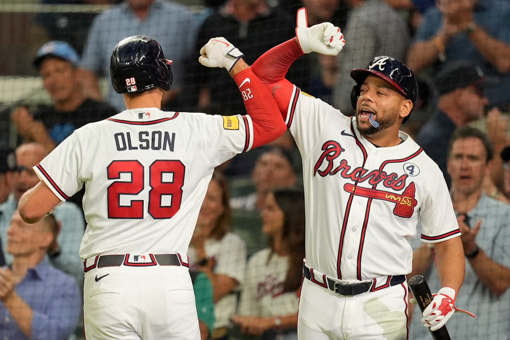 Atlanta Braves' Matt Olson (28) celebrates his solo homer with Dominic Smith in the sixth inning of a baseball game against the Toronto Blue Jays, Tuesday, June 2, 2026, in Atlanta. (AP Photo/Mike Stewart)