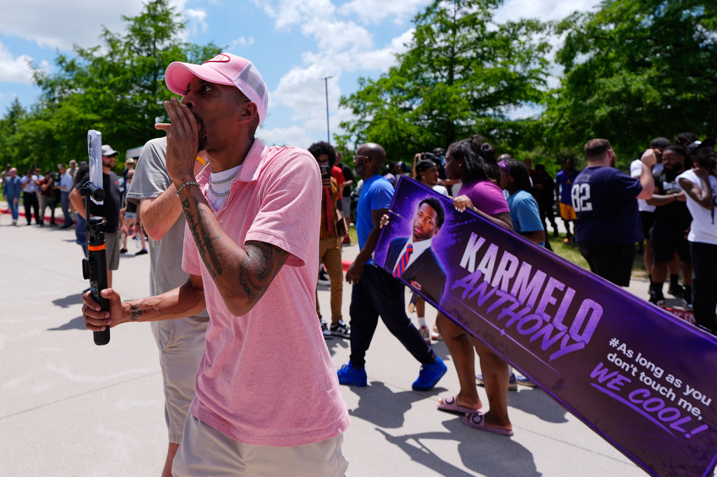 A person walks around announcing the guilty verdict in the Karmelo Anthony trial in front of the Collin County courthouse, Tuesday, June 9, 2026, in McKinney, Texas. (AP Photo/Tony Gutierrez)