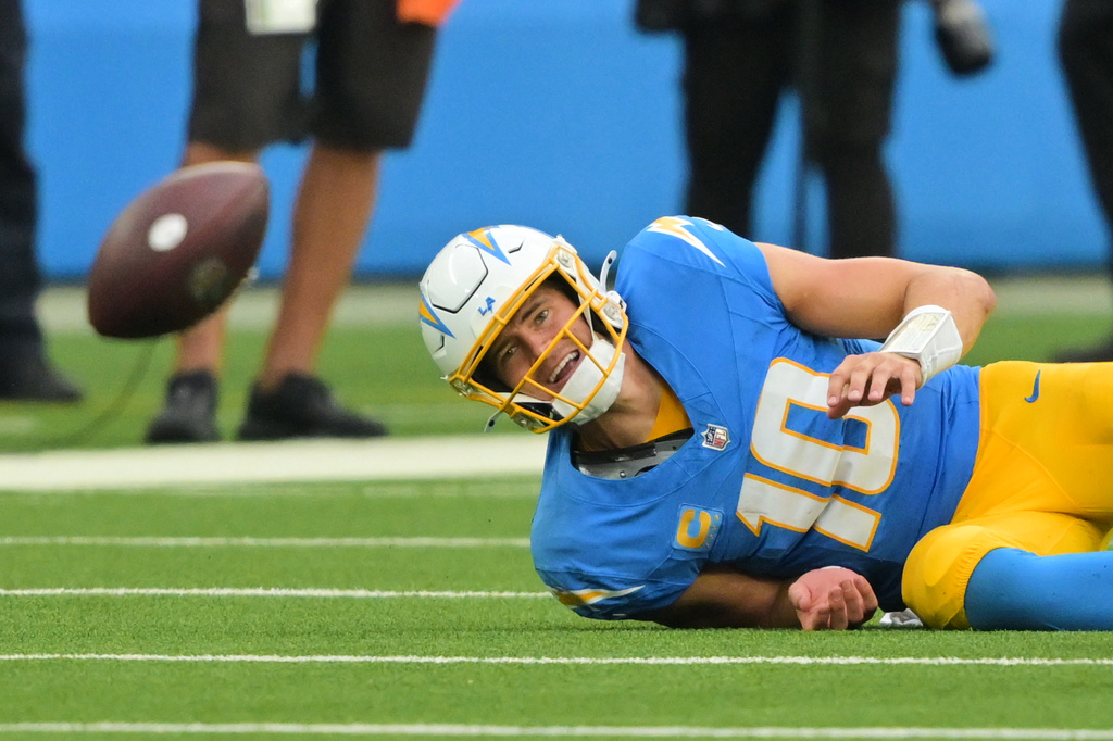 Los Angeles Chargers quarterback Justin Herbert (10) fumbles as he is tackled by Las Vegas Raiders defensive end Malcolm Koonce (51) during the second half of an NFL football game in Inglewood, Calif., Sunday, Sept. 20, 2026. (AP Photo/Jayne Kamin-Oncea)