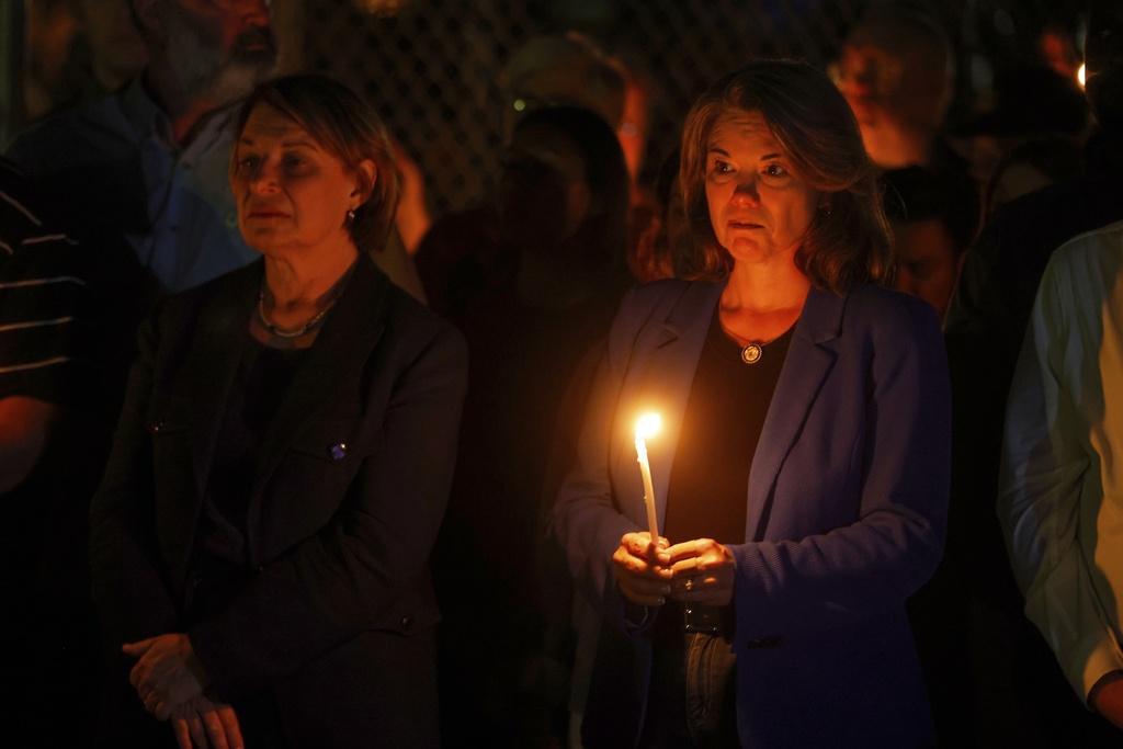 People gather at a vigil at Lynnhurst Park after a shooting at the Annunciation Catholic School Wednesday, Aug. 27, 2025, in Minneapolis. (AP Photo/Bruce Kluckhohn)
