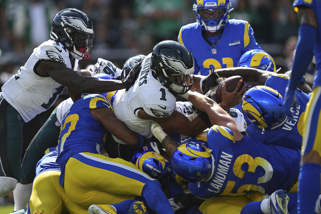 Philadelphia Eagles quarterback Jalen Hurts (1) struggles for yardage during the second half of an NFL football game against the Los Angeles Rams Sunday, Sept. 21, 2025, in Philadelphia. (AP Photo/Matt Rourke)