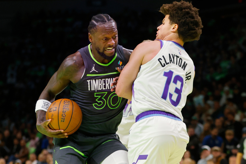 Minnesota Timberwolves forward Julius Randle (30) works around Utah Jazz guard Walter Clayton Jr. (13) in the first quarter of an NBA Cup basketball game Friday, Nov. 7, 2025, in Minneapolis. (AP Photo/Bruce Kluckhohn)