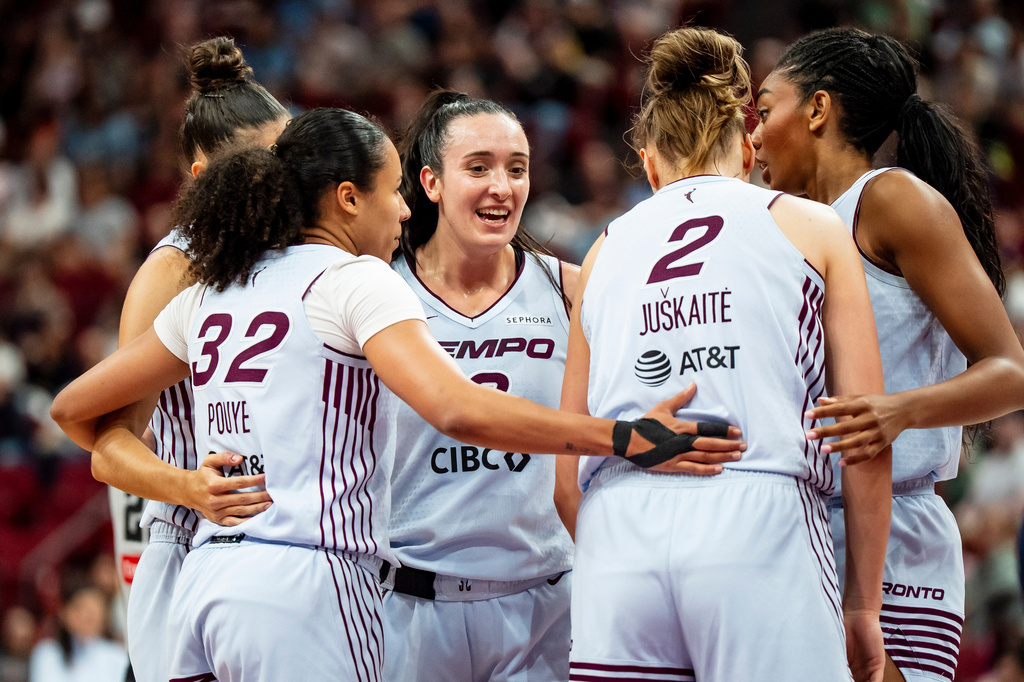 Toronto Tempo's Marina Mabrey, center, celebrates with teammates after drawing a foul against the Dallas Wings during the first half of a WNBA basketball game in Montreal, Friday, July 10, 2026. (Christopher Katsarov/The Canadian Press via AP)
