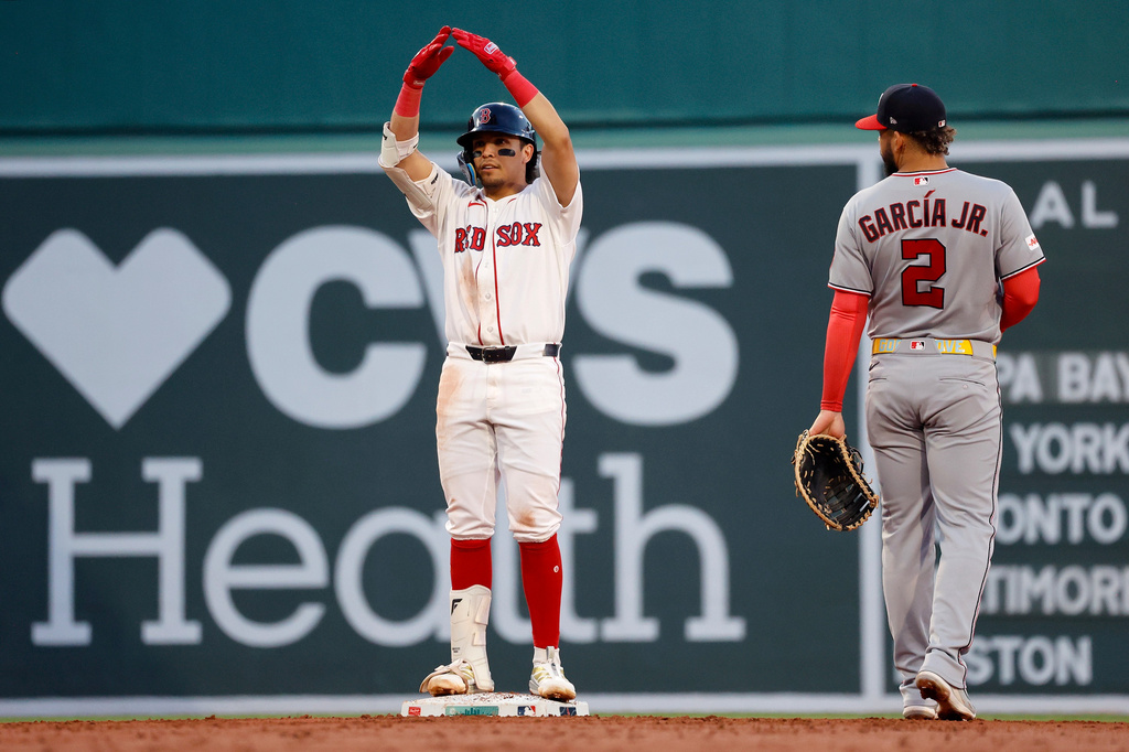 Boston Red Sox's Anthony Seigler, left, reacts to his dugout after hitting a double as Washington Nationals first baseman Luis García Jr. (2) looks on during the third inning of a baseball game, Monday, June 29, 2026, in Boston. (AP Photo/Mary Schwalm)