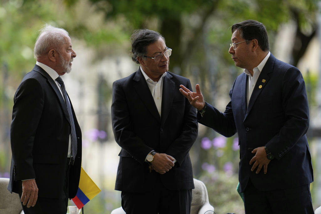 Bolivia's President Luis Arce, right, talks to Brazil's President Luiz Inacio Lula da Silva, left, and Colombia's President Gustavo Petro during a meeting of leaders of the Amazon Cooperation Treaty Organization in Bogota, Colombia, Friday, Aug. 22, 2025. (AP Photo/Fernando Vergara)