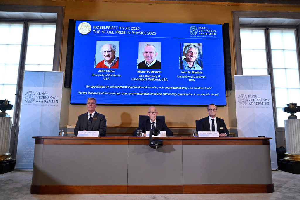 From left, Chair of the Nobel Committee for Physics Chair Olle Eriksson, Secretary General of the Swedish Academy of Sciences Hans Ellegren and Member of the Nobel Committee for Physics Goran Johansson announce John Clarke, Michel H Devoret and John M. Martinis, on screen behind, as the recipients the Nobel Prize in Physics, at the Nobel Assembly of the Karolinska Institutet, in Stockholm, Sweden, Tuesday, Oct. 7, 2025. (Christine Olsson/TT News Agency via AP)