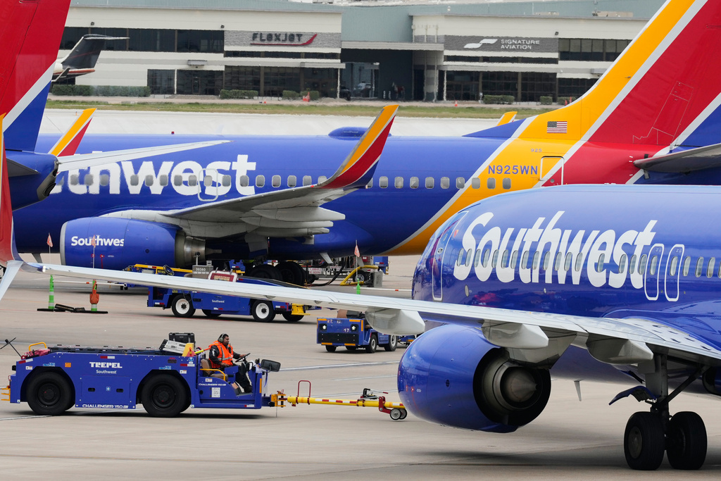 Flight line workers push a Southwest Airlines aircraft away from a gate at Love Field Airport in Dallas, Monday, March 16, 2026. (AP Photo/Tony Gutierrez)