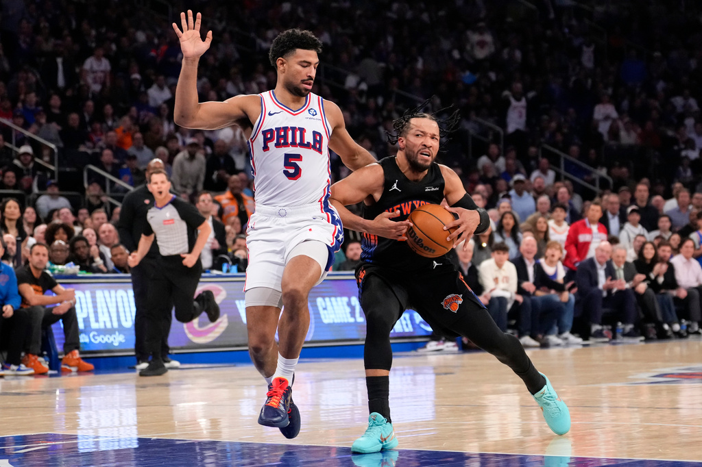New York Knicks guard Jalen Brunson, right, drives past Philadelphia 76ers guard Quentin Grimes (5) during the first half of Game 2 in a second-round NBA basketball playoffs series, Wednesday, May 6, 2026, in New York. (AP Photo/Yuki Iwamura)