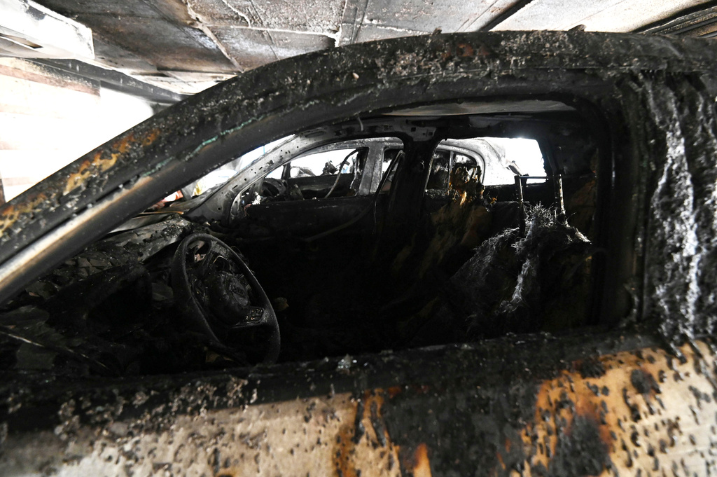 Burned vehicles are seen following firebomb attacks that apparently targeted members of Greece's governing conservative New Democracy party in the northern port city of Thessaloniki, Greece, Wednesday, July 1, 2026. (AP Photo/Giannis Papanikos)