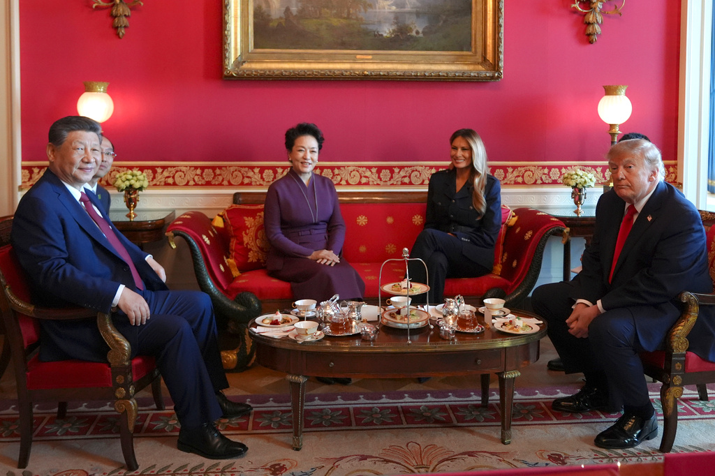 President Donald Trump, from right, and first lady Melania Trump attend a tea with China's President Xi Jinping, from left, and his wife Peng Liyuan in the Red Room of the White House, Friday, Sept. 25, 2026, in Washington. (AP Photo/Jacquelyn Martin)