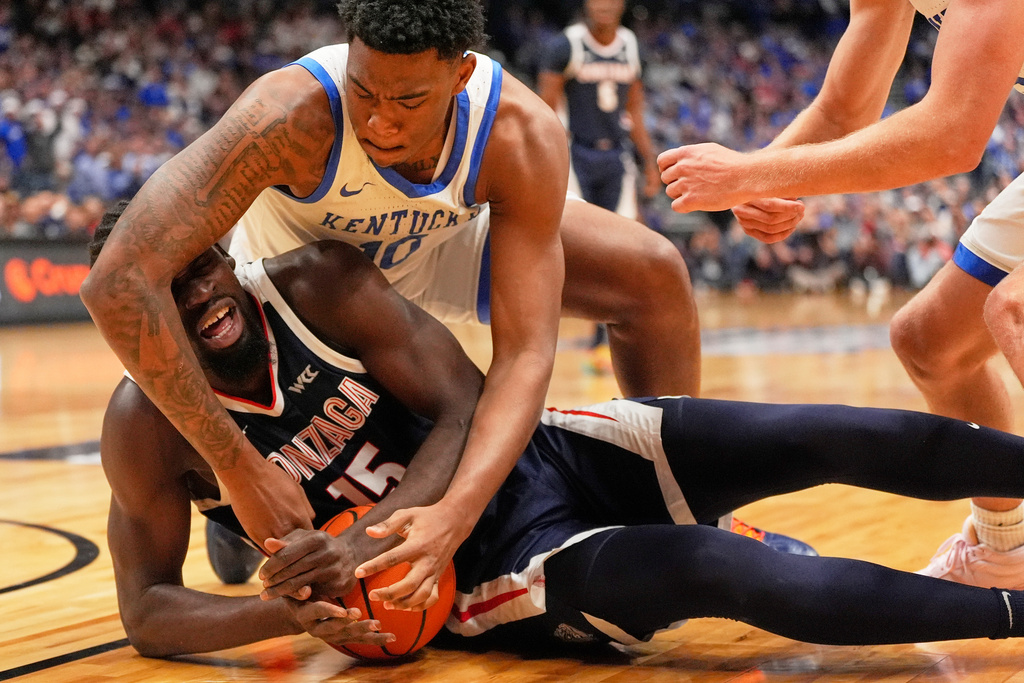 Kentucky forward Brandon Garrison (10) reaches for the ball as Gonzaga forward Graham Ike (15) calls a timeout during the first half of an NCAA college basketball game Friday, Dec. 5, 2025, in Nashville, Tenn. (AP Photo/George Walker IV)