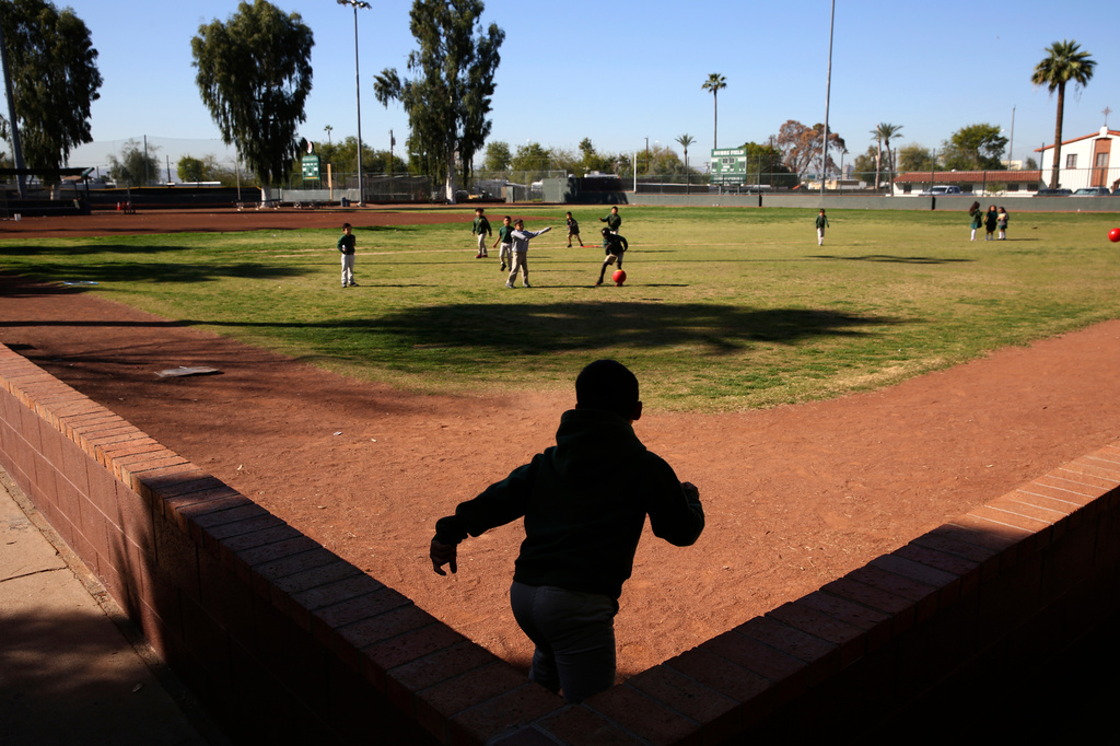 FILE- Students play ball during recess at the St. Agnes Elementary School in Phoenix, Ariz., on March 3, 2020. (AP Photo/Dario Lopez-MIlls, File)